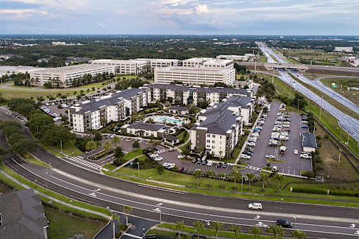 Aerial view of residential buildings with office complex at Avli At Crosstown Center Apartments, TAMPA, FL 33619