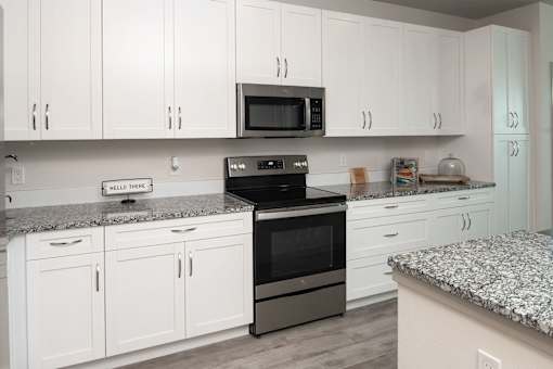 Modern kitchen with stainless steel appliances and island at Avli At Crosstown Center Apartments, TAMPA, 33619