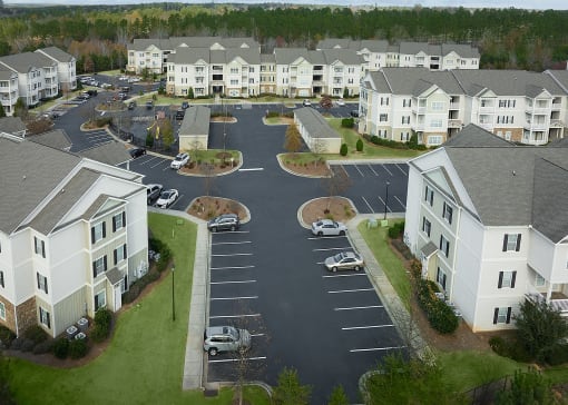 A parking lot in front of apartment buildings.