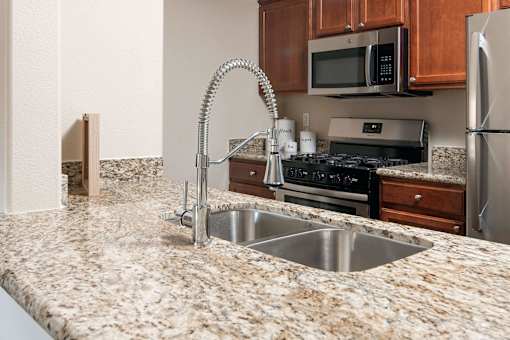 a kitchen with granite counter tops and a sink