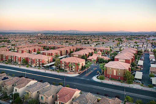an aerial view of a city with houses and an intersection