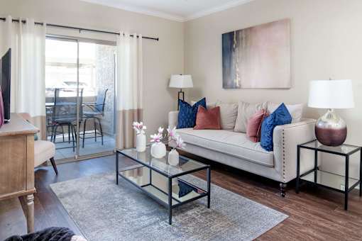 a living room with a couch and a glass coffee table