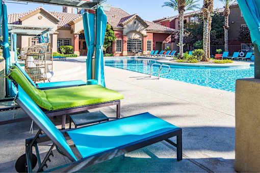 A poolside area with sun loungers and a pool.