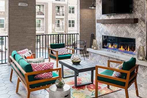 Outdoor lounge with fireplace at Pointe at Lake Crabtree Apartments, North Carolina