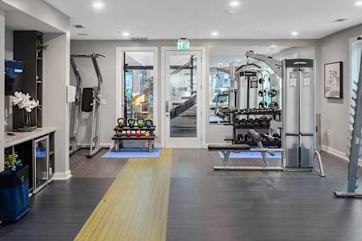 Gym with weights at Pointe at Lake Crabtree Apartments, North Carolina, 27560