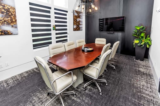 a conference room with a table and chairs