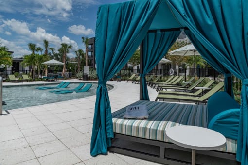 a swimming pool with chaise lounge chairs and a table