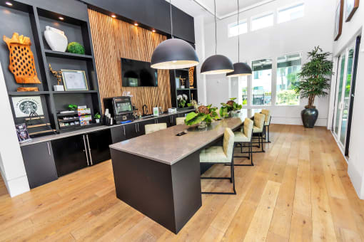 a large kitchen with a long counter and chairs
