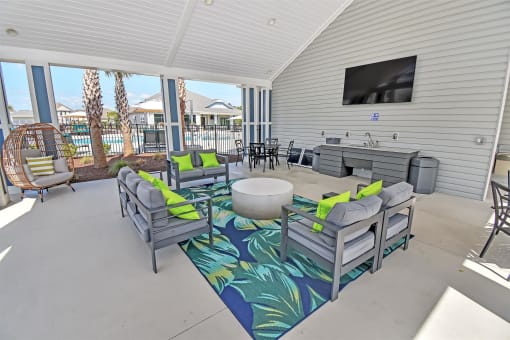 gather around the fire pit in the covered patio and watch the game on the flat screen tv