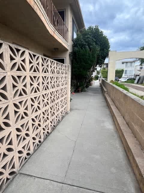 A concrete balcony with a decorative pattern is seen.