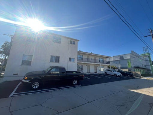 A black truck is parked on the side of a street.