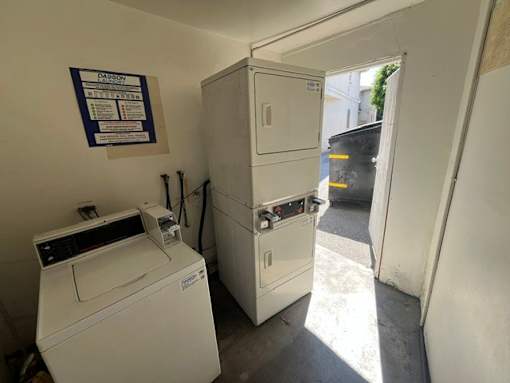 A white washing machine and dryer in a small room.