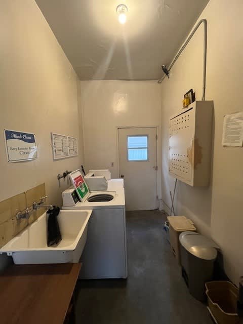 A bathroom with a toilet, sink, and a sign that says "No Flush Closet".