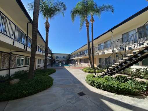 A sunny day at the apartment complex with a clear blue sky.