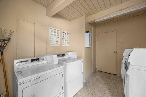 A laundry room with washers and dryers.