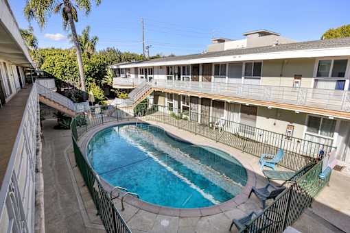 A small pool with a metal fence around it.
