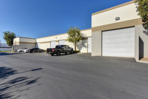 Arrow Business parking lot showing that there are spaces available with warehouse access including roll up doors.