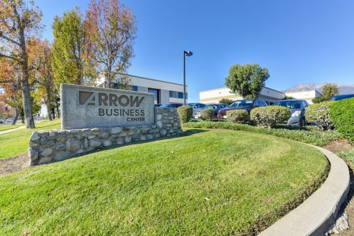Arrow Business Monument Signage outside with green grass surrounding it. 