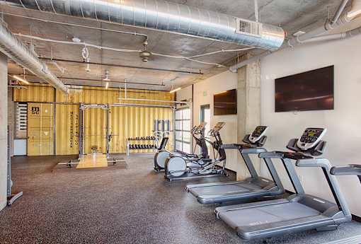 A gym with treadmills and exercise equipment.