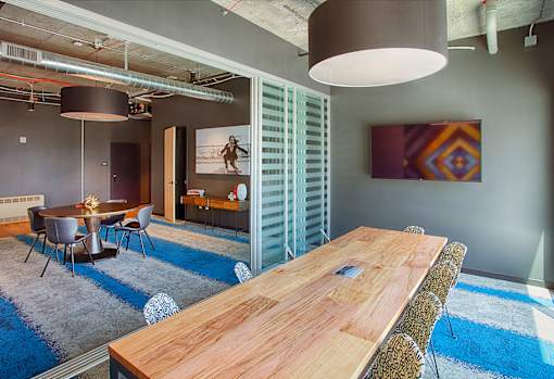 A conference room with a long table and chairs.