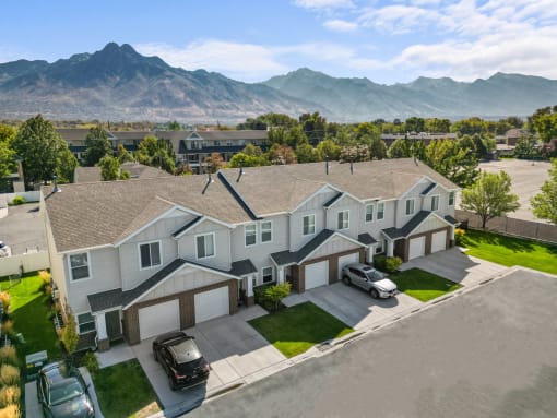 an aerial view of a house with cars parked in front of it