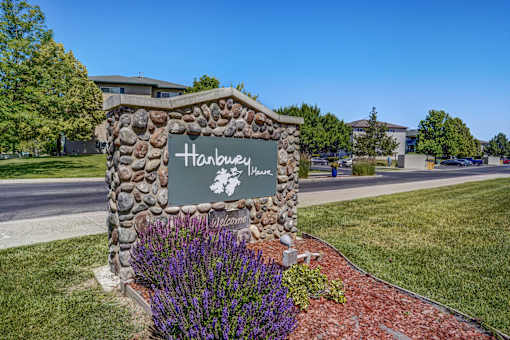 A stone sign that says Hanbury in front of a building.