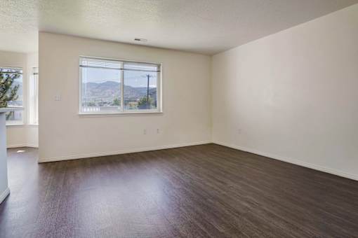 Empty room with a window overlooking the street.