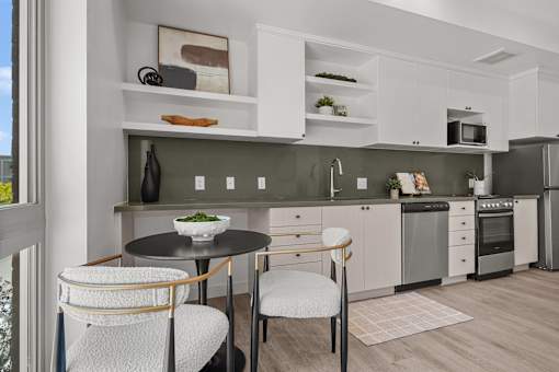 A modern kitchen with a table and chairs.