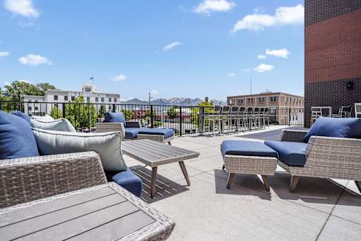 A patio with wicker furniture and a table.
