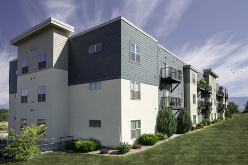 a picture of an apartment building with a blue sky in the background