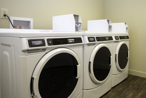 a washer and dryer sit side by side in a laundry room