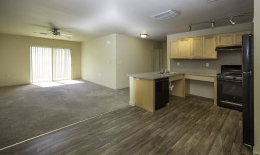an empty living room and kitchen