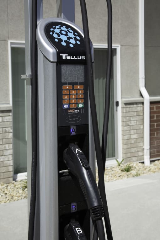 a close up of a telstra pay phone in front of a building