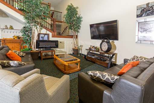 A living room with a grey couch and a wooden coffee table.