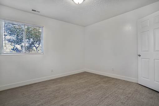 A room with a window and a door.
