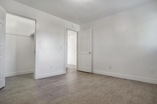 A white room with a door and a window.