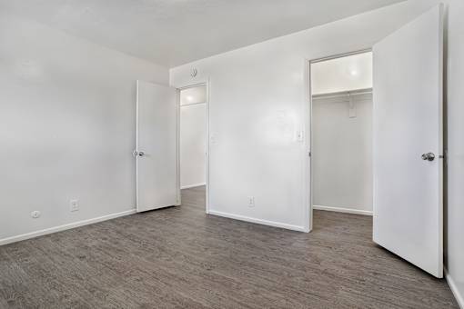 A room with white walls and a grey floor.