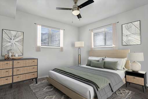 A bedroom with a large bed and a painting on the wall.