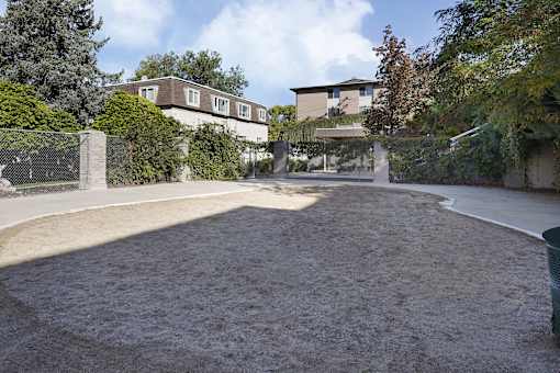 A large, empty driveway leads to a house.
