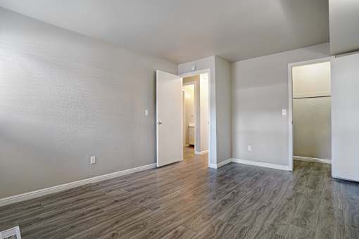 A room with a wooden floor and white walls.