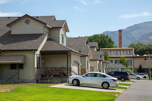 a row of houses with mountains in the background