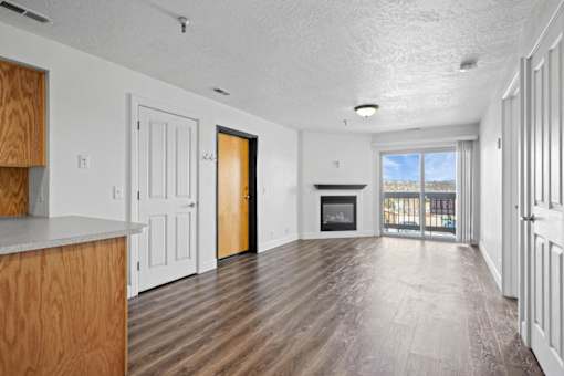 A spacious living room with a fireplace and sliding glass doors.