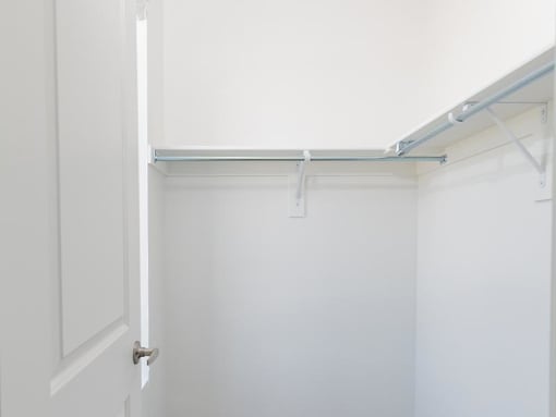 a white closet with a white door and white walls