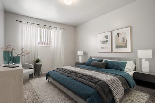 a bedroom with a bed and two pictures on the wall