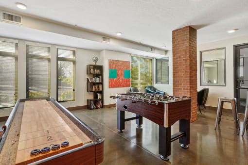 a game room with a foosball table and a pool table
