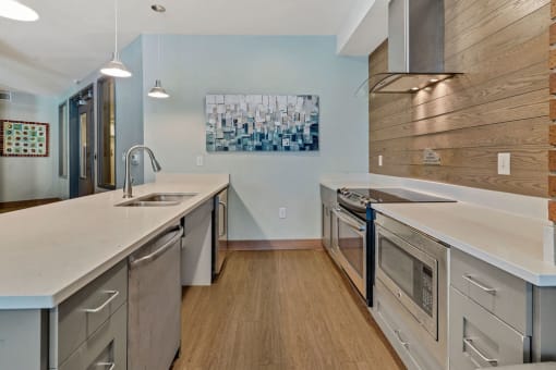 a kitchen with stainless steel appliances and white counter tops