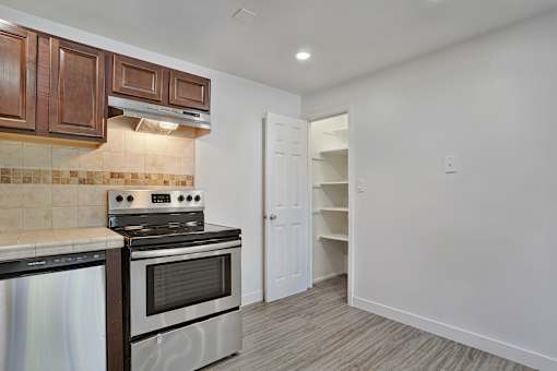 A kitchen with a stove top oven and a microwave.