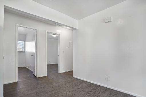 A white room with a doorway leading to another room.