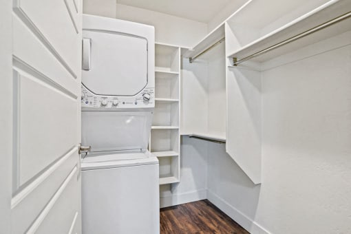 a white laundry room with a washer and dryer in it