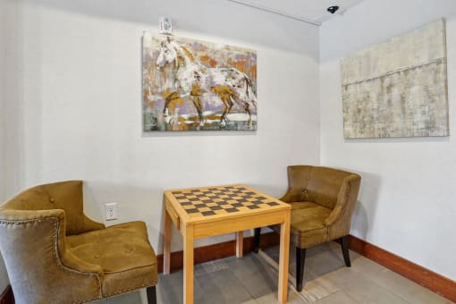 a game room with a chess board and chairs
